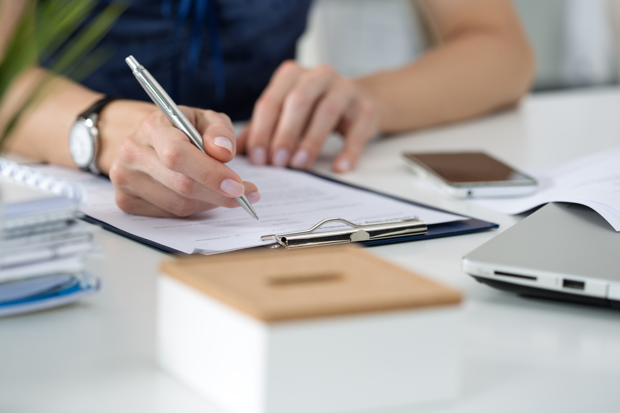 Femme qui rempli l'attestation d'accessibilité d'un ERP